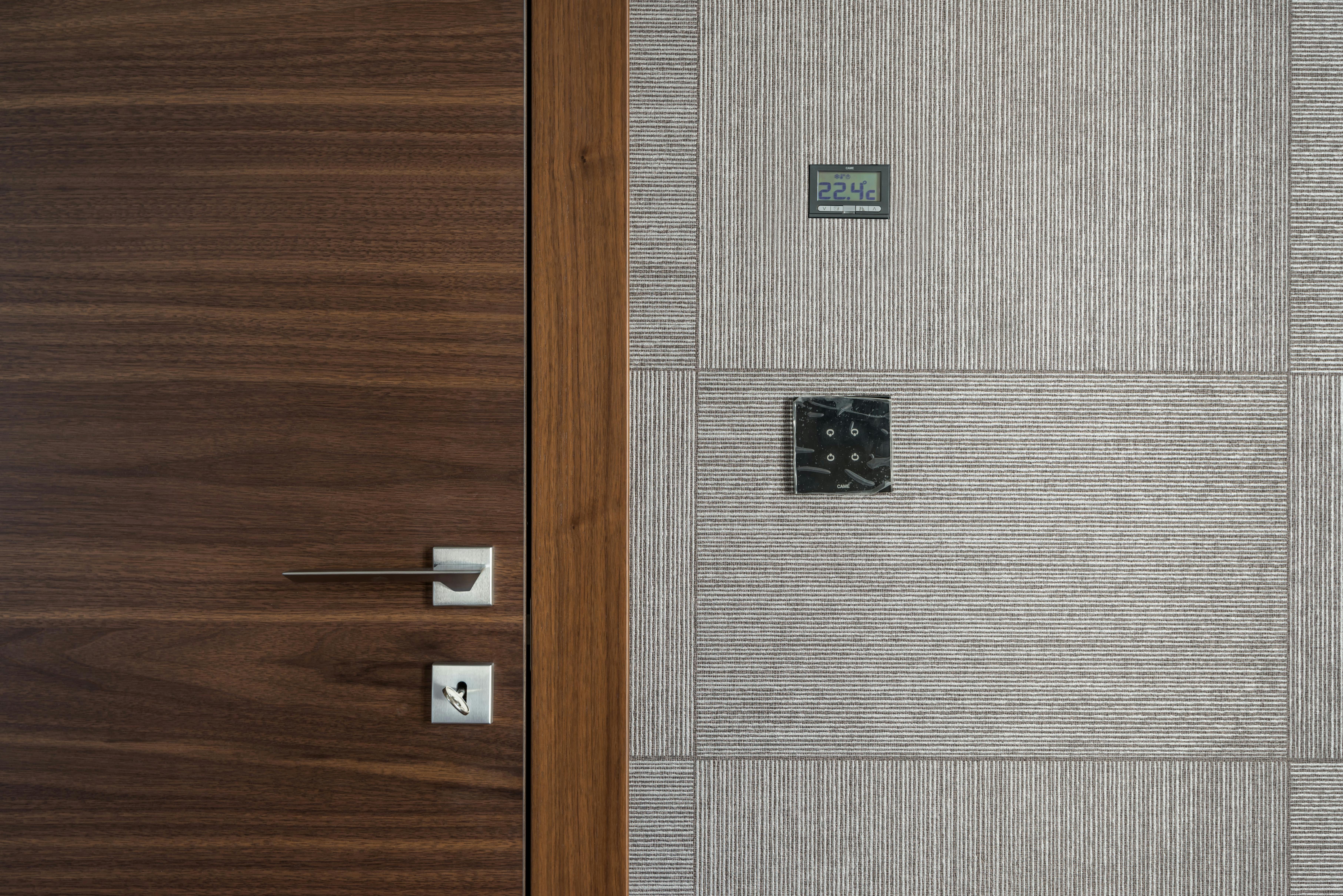 Two outdoor central air conditioning units installed on concrete pads next to a building, ready for operation.